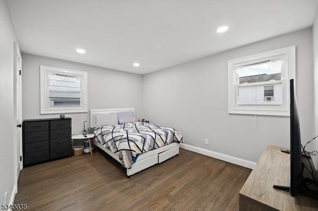 bedroom with recessed lighting, dark wood finished floors, and baseboards