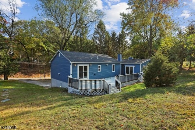 view of front of house with a front yard and a wooden deck