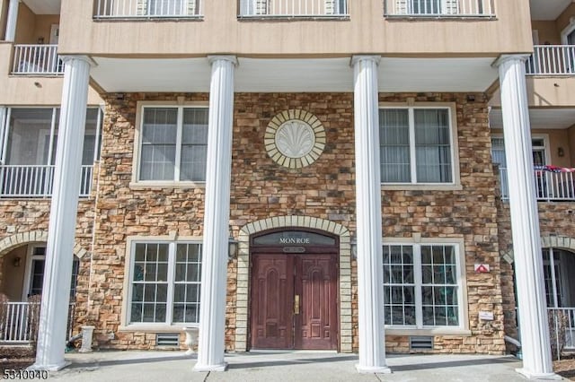 entrance to property with stone siding