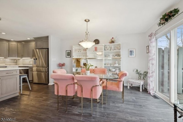 dining space with dark wood-style flooring and recessed lighting