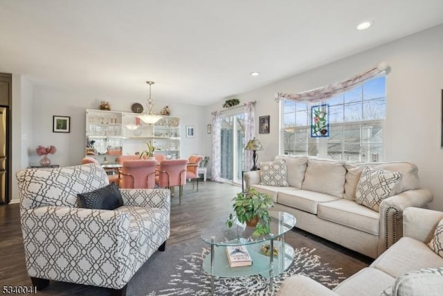 living area with recessed lighting and dark wood-style flooring