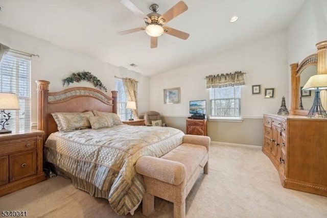 bedroom with lofted ceiling, light colored carpet, ceiling fan, and baseboards