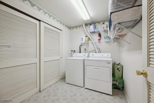 laundry room featuring baseboards, laundry area, and washer and dryer