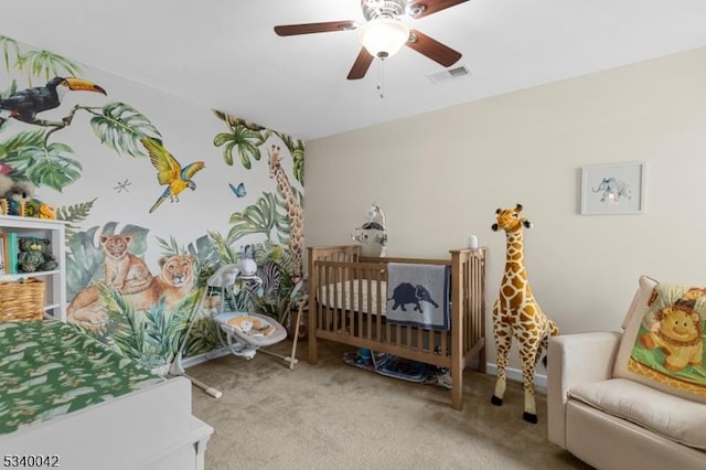 carpeted bedroom featuring visible vents and a ceiling fan