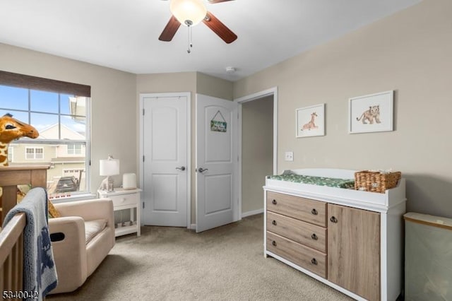 living area featuring ceiling fan and light colored carpet