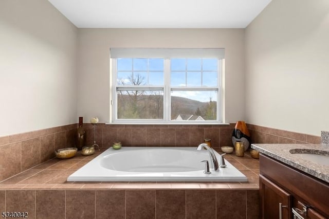 bathroom featuring a garden tub and vanity