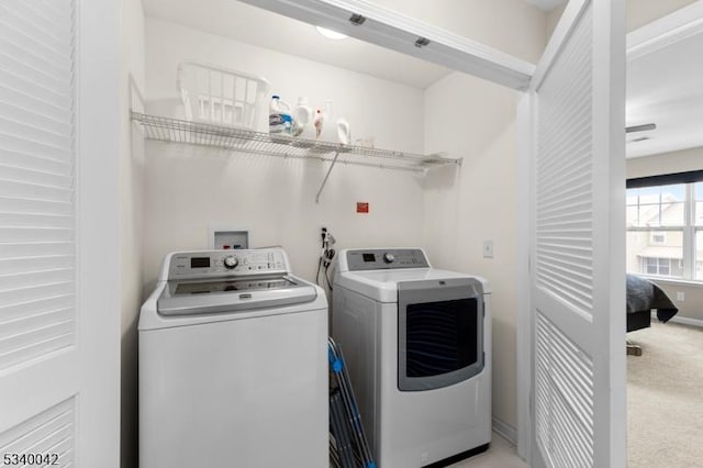 clothes washing area with carpet, laundry area, independent washer and dryer, and baseboards