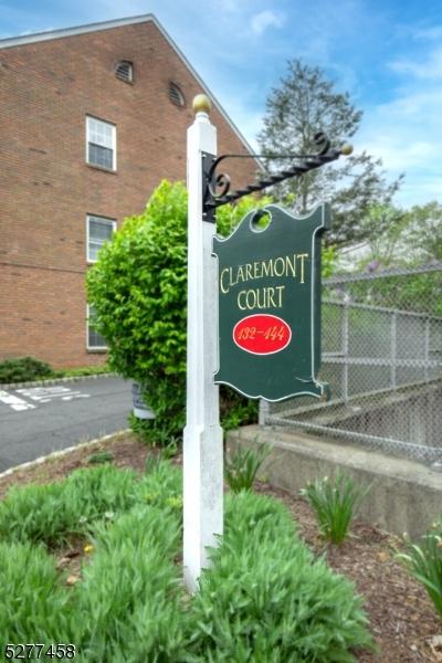 community / neighborhood sign with fence