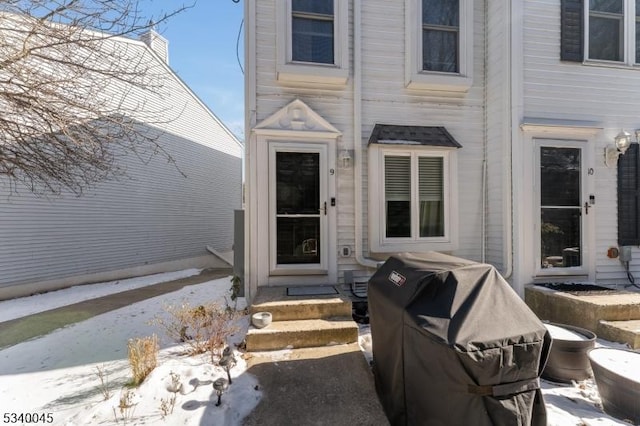 view of snow covered property entrance