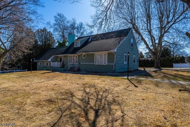 view of front of home featuring a chimney and a front yard