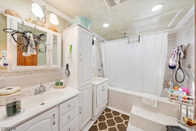 full bath with visible vents, tiled shower / bath combo, tile patterned flooring, vanity, and tile walls