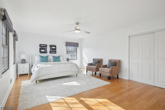 bedroom with ceiling fan, a closet, and wood finished floors