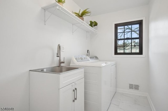 clothes washing area featuring baseboards, visible vents, washer and clothes dryer, marble finish floor, and a sink