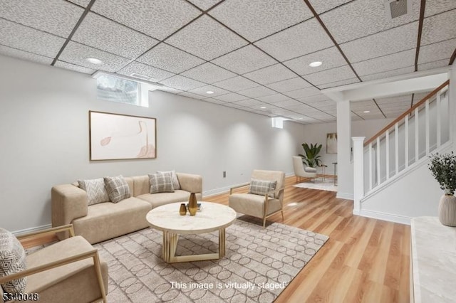 living room with baseboards, stairway, wood finished floors, a paneled ceiling, and recessed lighting