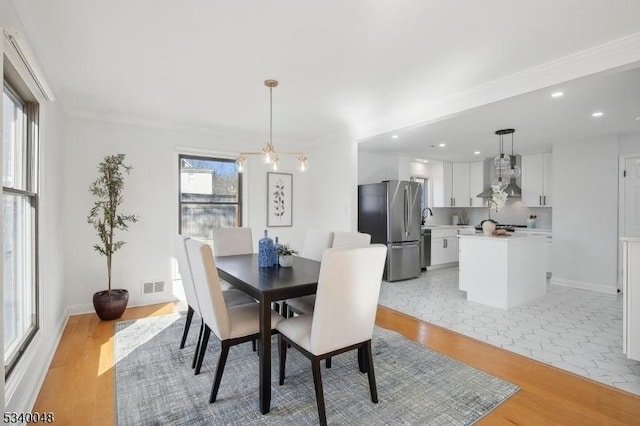 dining space featuring recessed lighting, visible vents, light wood finished floors, and an inviting chandelier