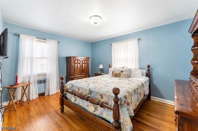 bedroom featuring baseboards and wood finished floors