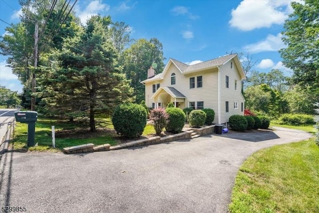 view of front of home featuring a chimney