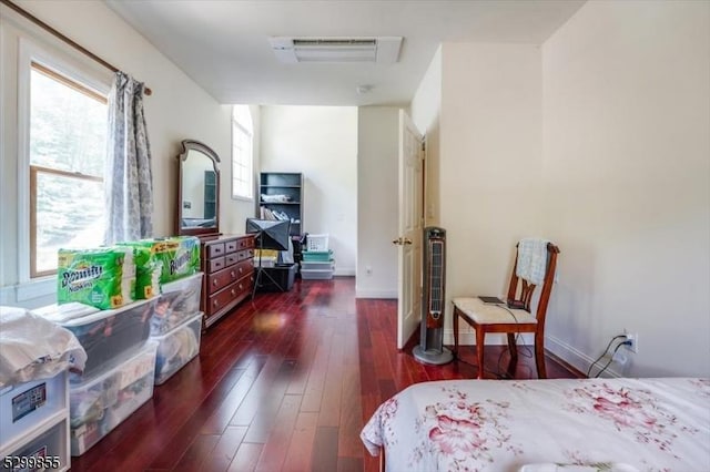 bedroom with dark wood-style floors and baseboards