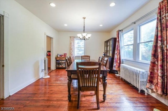 dining space featuring an inviting chandelier, radiator heating unit, dark wood-type flooring, and recessed lighting