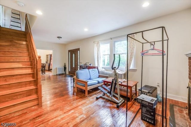 workout room featuring baseboards, radiator heating unit, wood finished floors, and recessed lighting