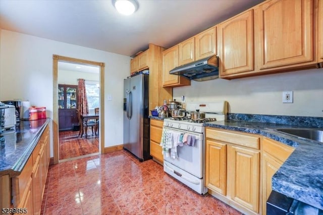 kitchen with stainless steel fridge with ice dispenser, dark countertops, white gas range, under cabinet range hood, and light brown cabinets