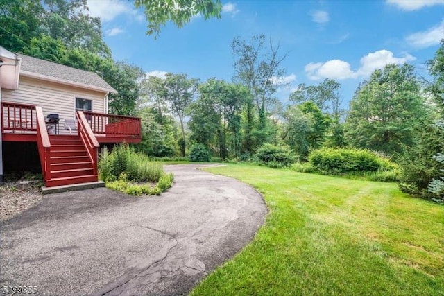 view of yard featuring a deck and stairway