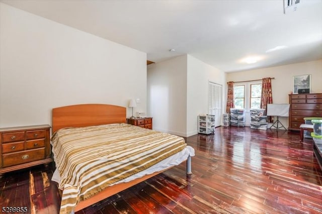 bedroom featuring a closet, baseboards, and wood finished floors