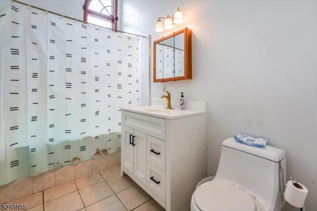 full bathroom featuring tile patterned flooring, shower / bathtub combination with curtain, vanity, and toilet