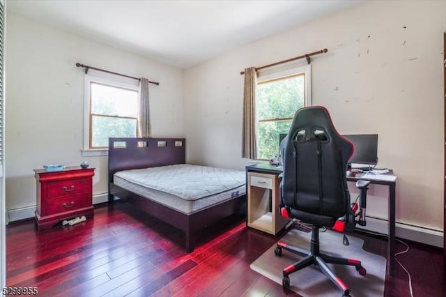 bedroom with dark wood-style floors and a baseboard radiator