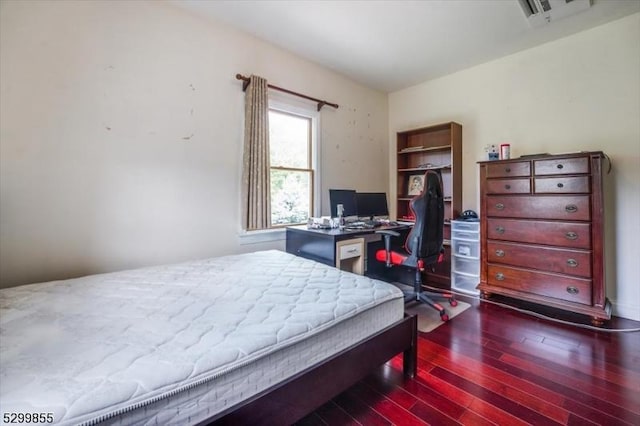 bedroom featuring visible vents and dark wood-type flooring