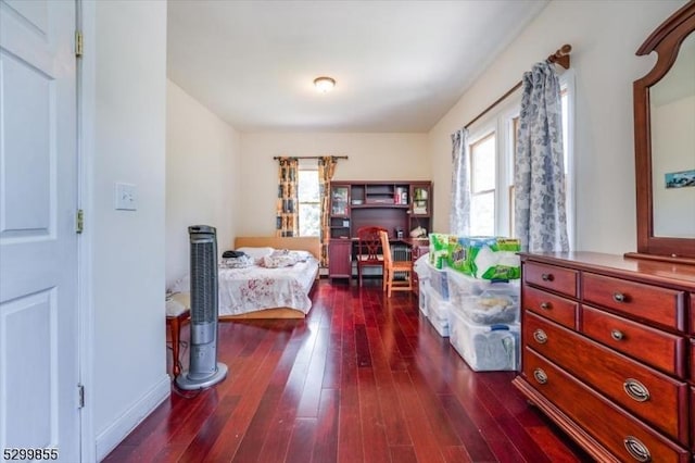 bedroom with dark wood-style flooring