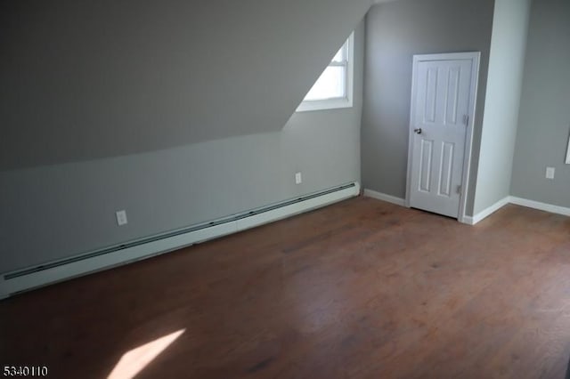 additional living space featuring lofted ceiling, a baseboard radiator, baseboards, and wood finished floors