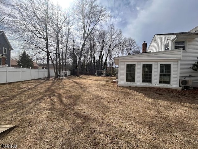 view of yard featuring ac unit and fence