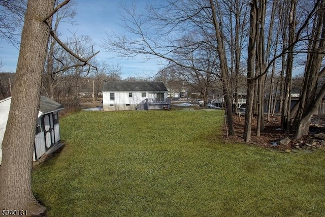 view of yard with a storage shed and an outdoor structure