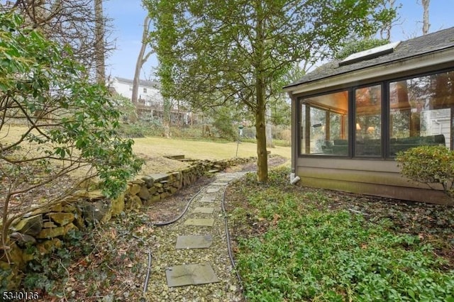 view of yard with a sunroom