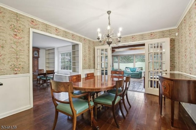 dining area with french doors, a wainscoted wall, and wallpapered walls