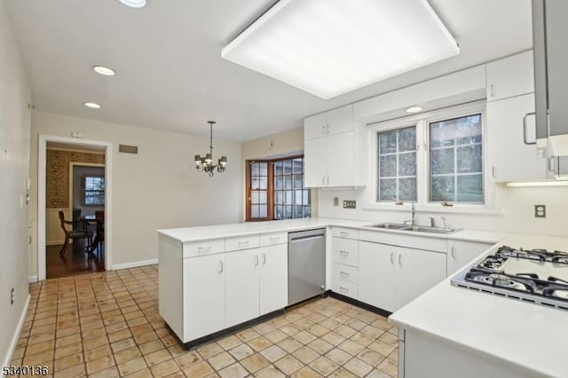 kitchen with a peninsula, a sink, white cabinetry, light countertops, and dishwasher