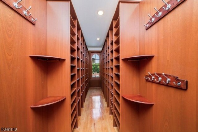 wine room featuring wood finished floors and recessed lighting