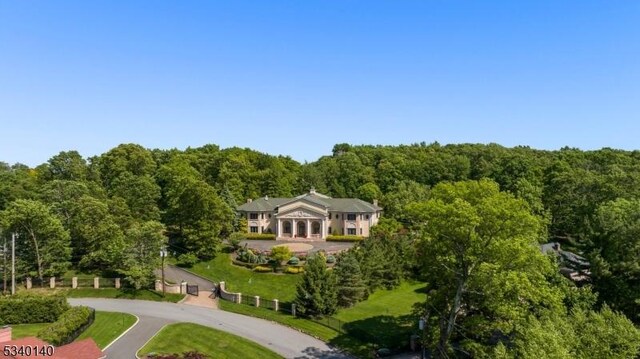 birds eye view of property featuring a view of trees