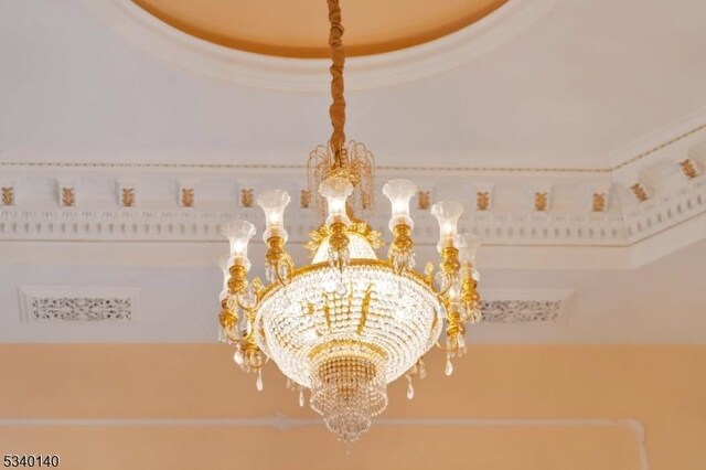 interior details featuring an inviting chandelier