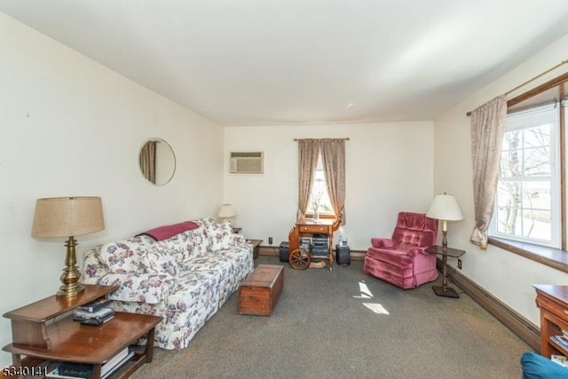 living area featuring carpet flooring, baseboards, and a wall mounted AC