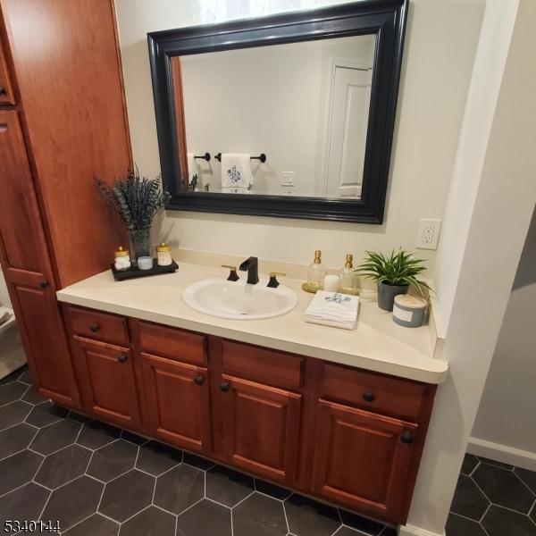 bathroom featuring tile patterned flooring and vanity