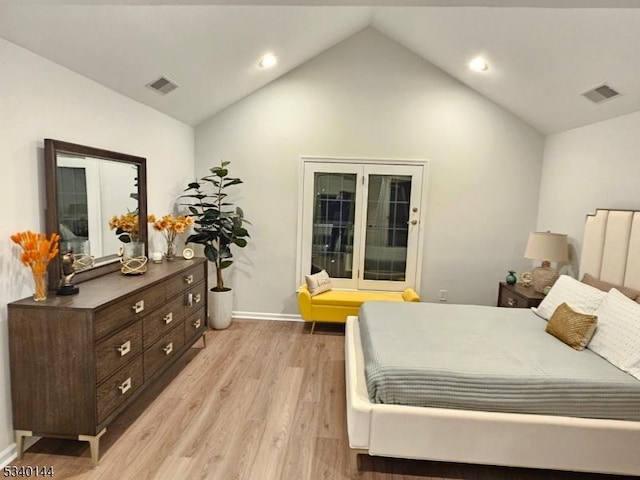 bedroom featuring light wood-type flooring, visible vents, vaulted ceiling, and baseboards