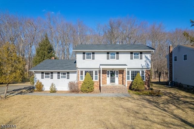 view of front of property with brick siding and a front lawn