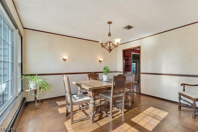 dining room featuring a baseboard radiator, a notable chandelier, visible vents, baseboards, and ornamental molding