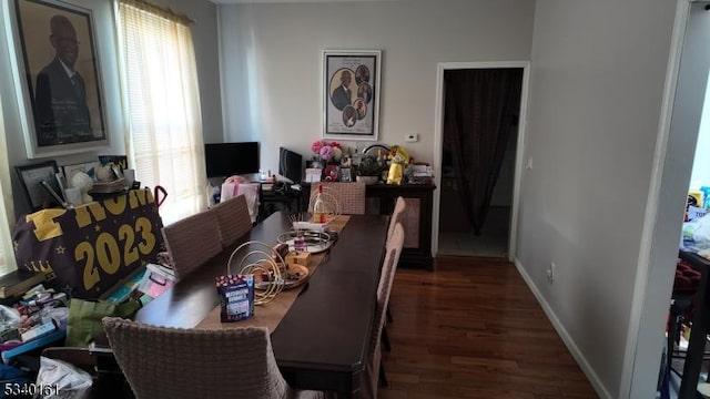 dining room with baseboards and wood finished floors