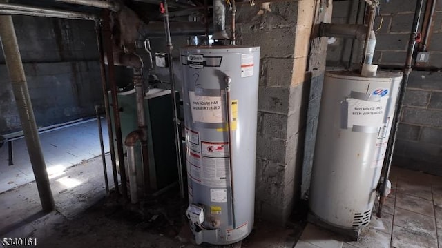 utility room featuring water heater