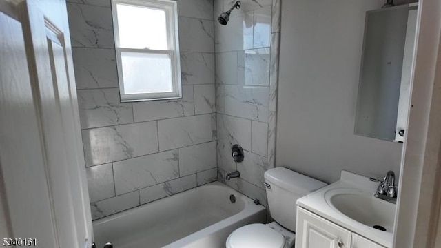 bathroom featuring toilet, shower / bath combination, and vanity