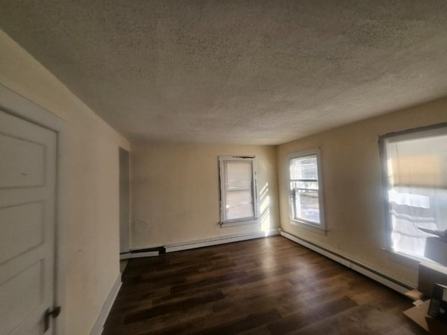 unfurnished room featuring a baseboard radiator, a textured ceiling, baseboards, and dark wood-type flooring