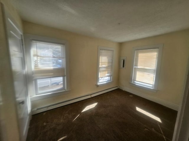 unfurnished room with a baseboard radiator, baseboards, dark colored carpet, and a textured ceiling